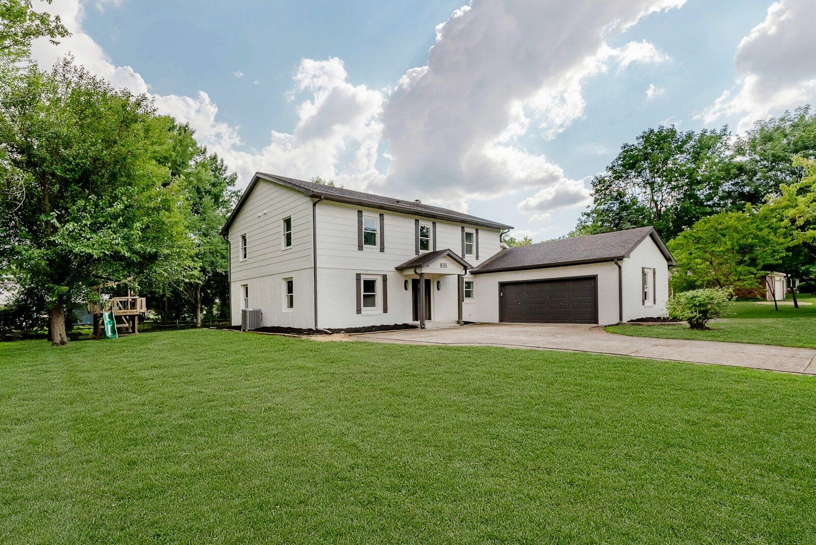 A white two-story house with a garage
